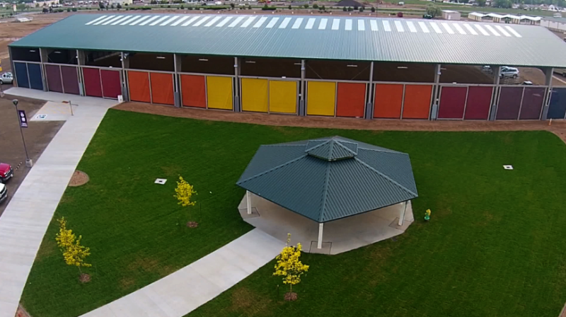 Aerial photograph showing the Gazebo surrounded by grass area and three small trees with the CW Construction Arena in the background