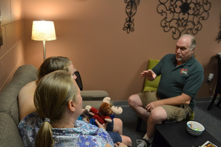 Photograph of a Victim Services Representative speaking to clients