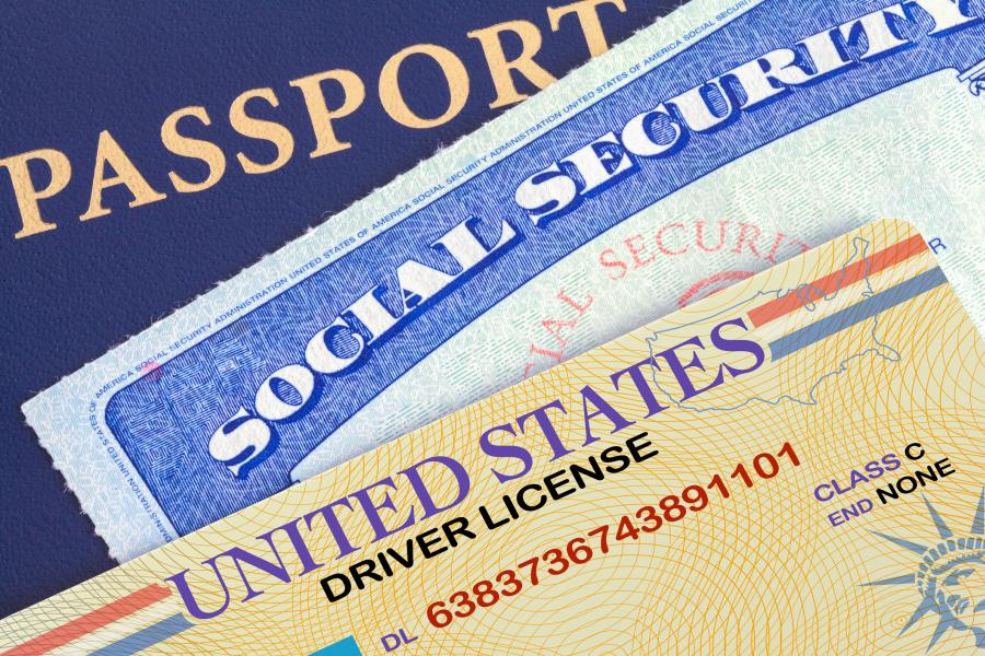 Photograph of Identification Documents - Drivers License, Social Security Card, and Passport in a pile