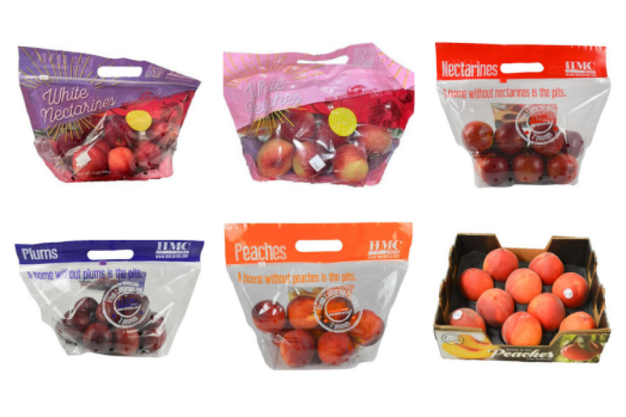 Plastic bags of peaches, plums, and nectarines. Cardboard box filled with peaches.