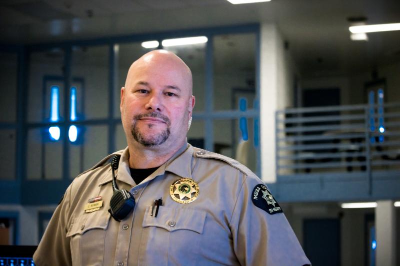 Photograph of male Detentions Deputy in uniform in the Detention area