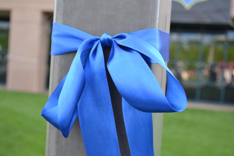 Photograph of a blue ribbon tied around a post for pro-law enforcement as a reminder of law enforcement personnel who have made the ultimate sacrifice and in honor of those men and women who serve their communities