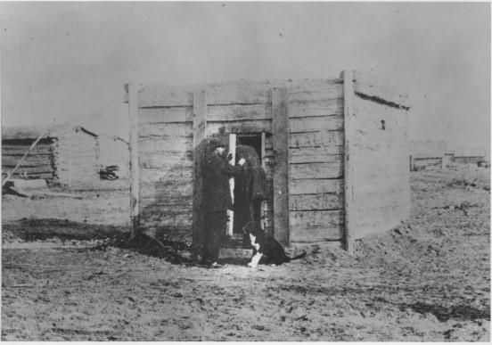 Historical photograph of a deputy placing an inmate in a old jail building