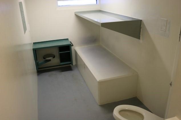 Historical photograph of inside a solitary confinement cell at the jail