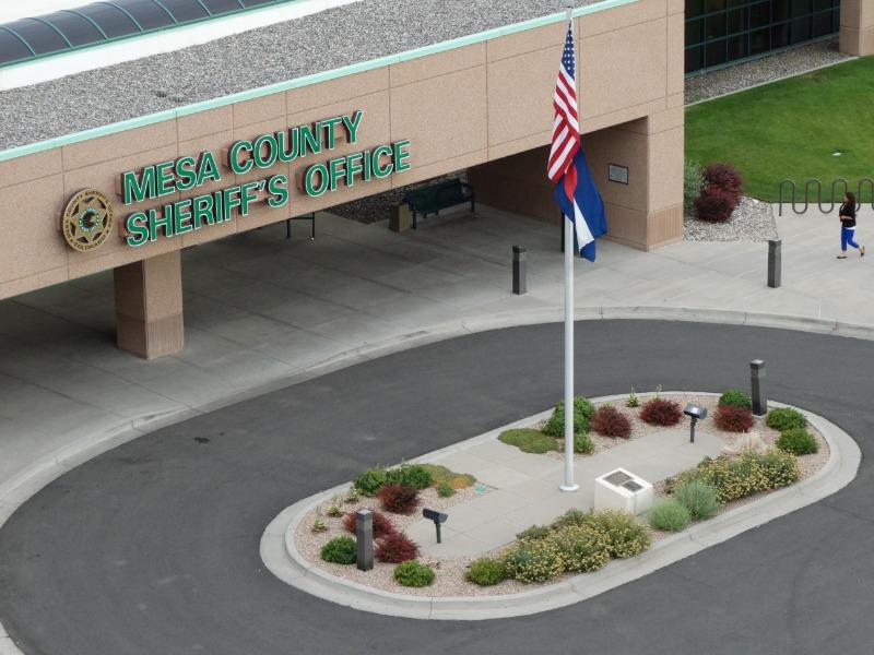 Arial Photograph of outside of Mesa County Sheriff's Office building showing driveway and flag pole with U.S. and State of Colorado flags