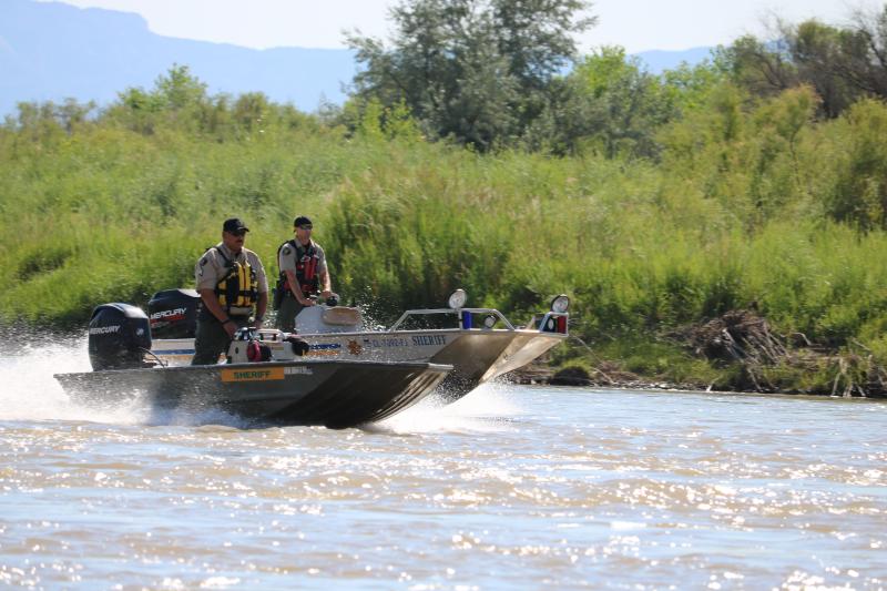 Photograph of two Mesa County Sheriff Deputies in boat on river