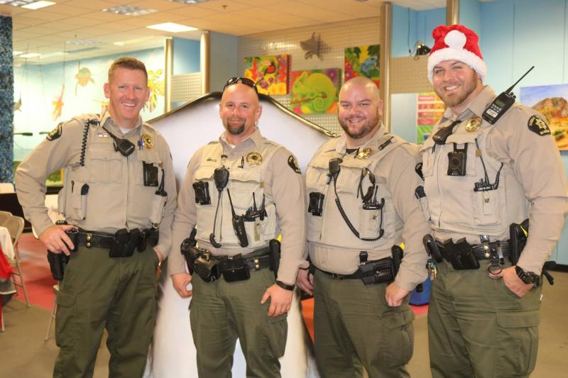 Photograph of four Mesa County Sheriff Deputies at Shop with a Cop event