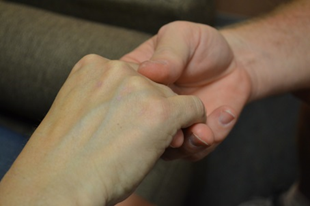 Photograph of a Victim Services Representative holding hand of a client