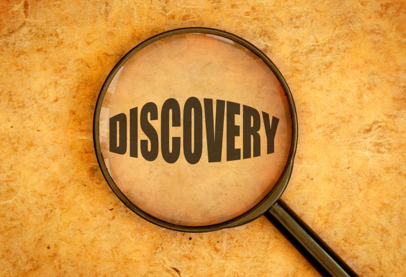 Photograph of Magnifying Glass focused on the word Discovery