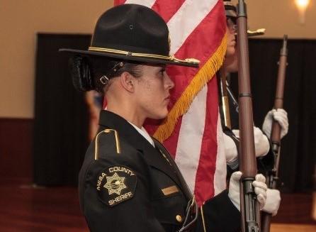 Photograph of Mesa County Sheriff Honor Guard in line carrying rifles and US flag