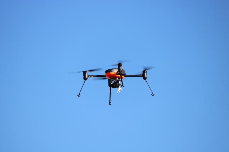 Photograph of Drone with camera on the bottom flying