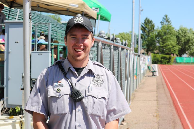 Photograph of a volunteer for the Mesa County Sheriff's Office working at event held at the Lincoln Park track