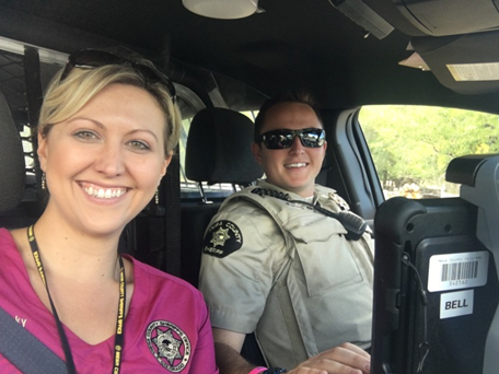 Photograph of volunteer on a ride along with a Mesa County Sheriff Deputy in vehicle