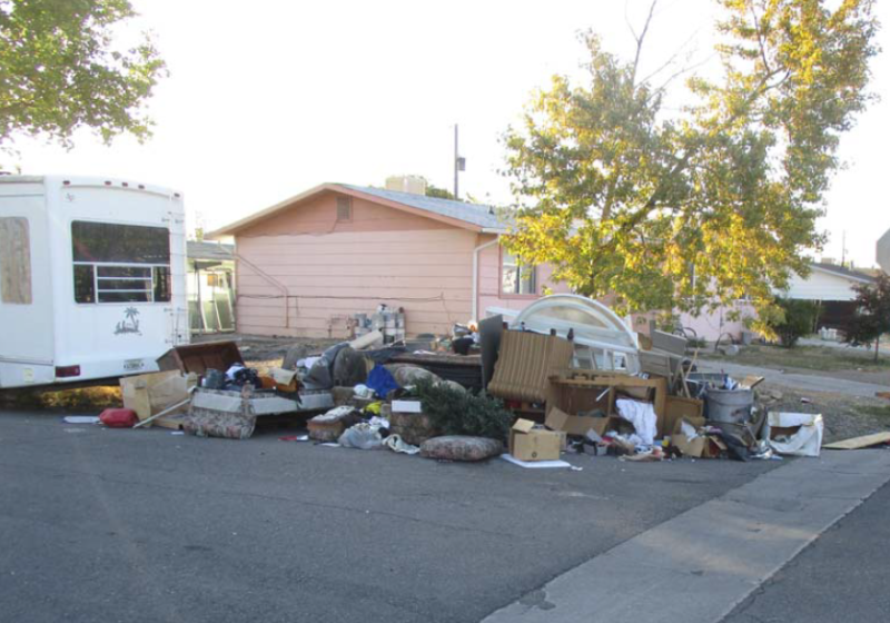 Trash pile next to residence