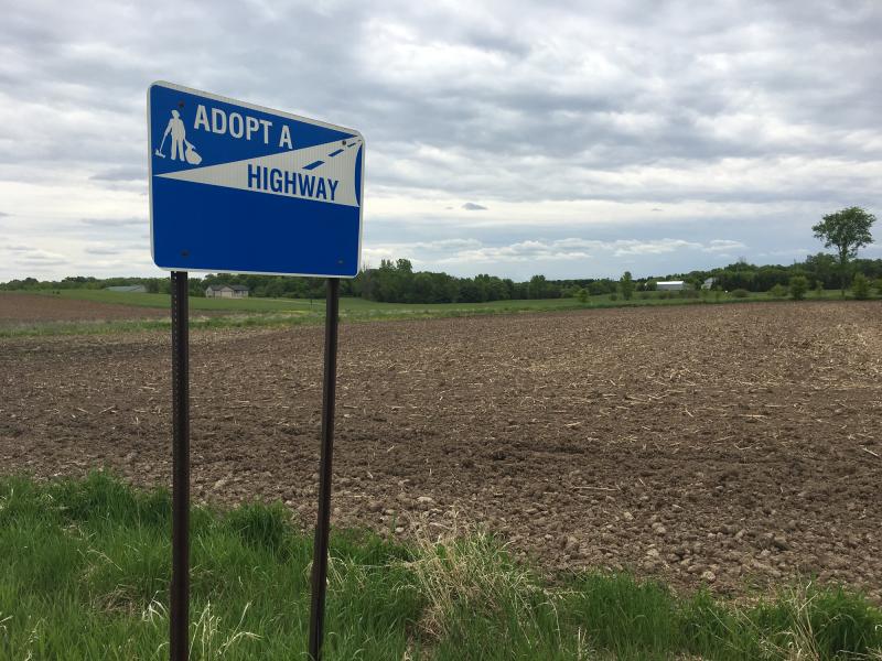 Photograph of Adopt a Highway Sign - Rural with tilled field in the background