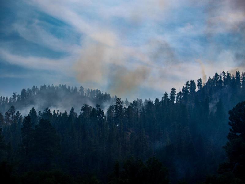 Photograph of Forest Fire Smoke in sky over mountains