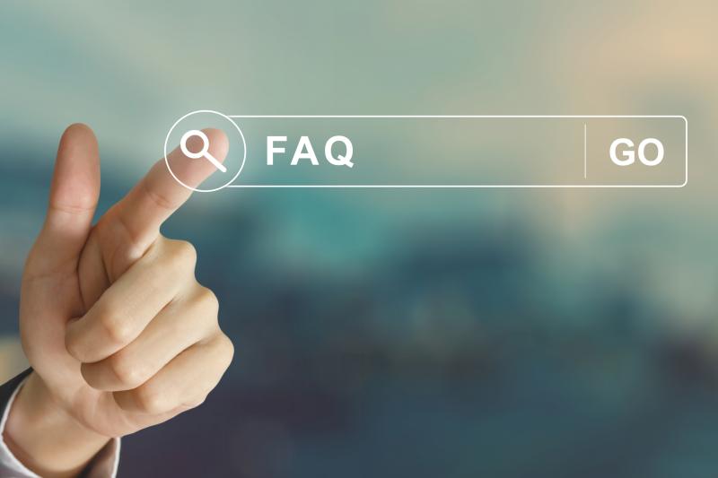 Photograph of Business hand clicking FAQ or Frequently asked questions button on search toolbar with vintage style effects.