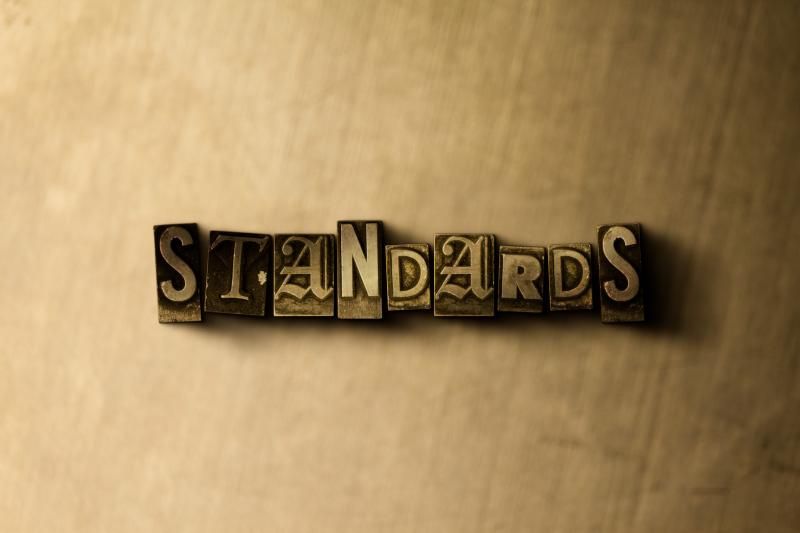 Concept photograph for Standards.  Vintage typeset on metal backdrop