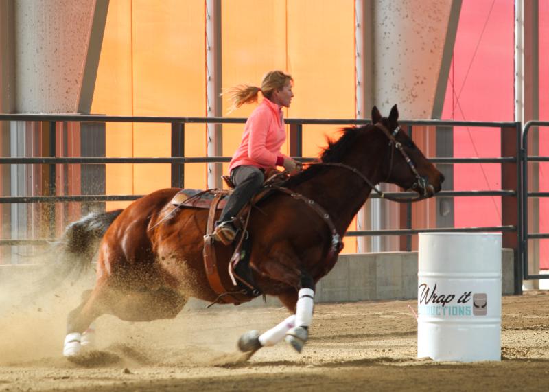 Photograph of horse barrel racing in CW Construction Arena