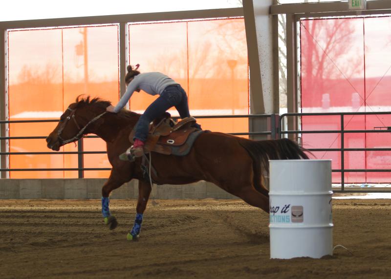Photograph of horse barrel racing in CW Construction Arena