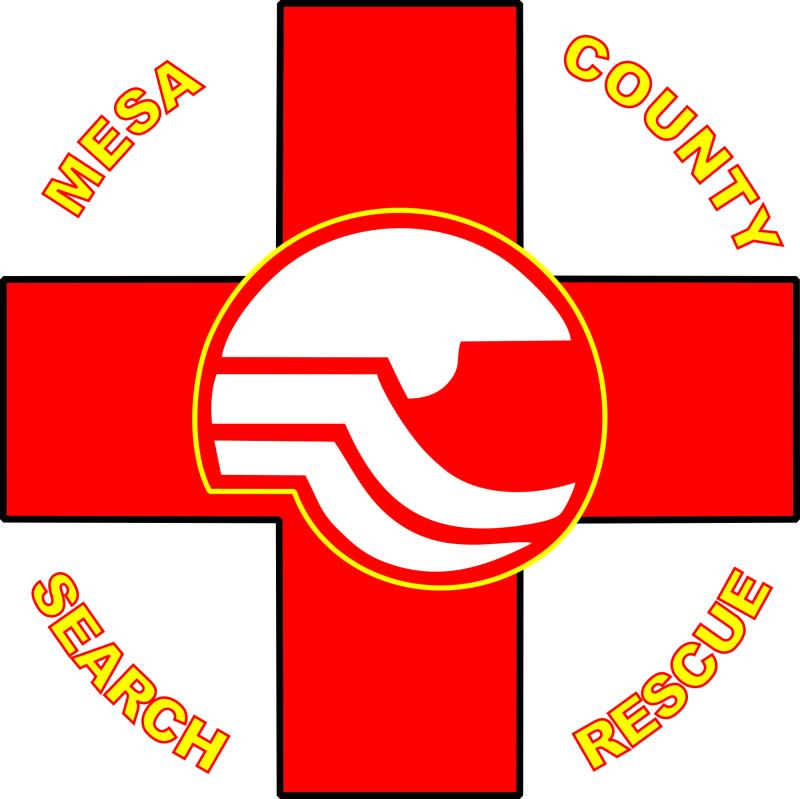 There is a red cross with the Mesa County logo in the middle. The word MESA is in the upper left corner, COUNTY in the upper right corner, SEARCH in the lower left, and RESCUE in the lower right in gold.