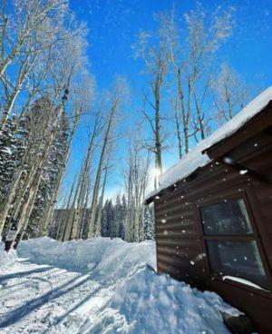 Page Image - Log cabin on the Grand Mesa with fresh snow by Senior Trial Deputy Roundy 