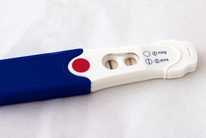 Blue and white pregnancy test showing a positive with two lines. 