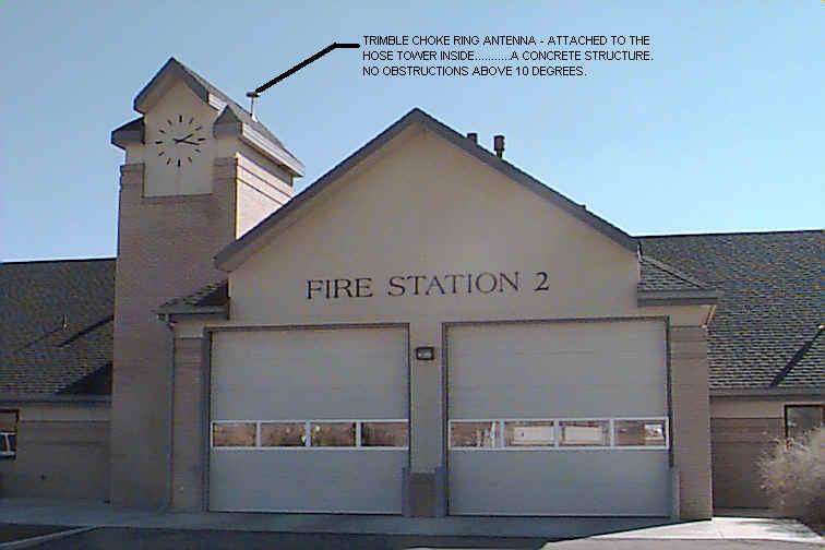 Fire Station 2 with 2 garage doors and a analogue clock showing on the hose tower, with the antenna attached to the hose tower inside a concrete structure. No obstructions above 10 degrees. 