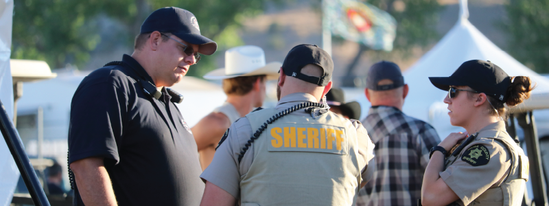 Two MCSO Deputies talk with a community member during Country Jam 2023.