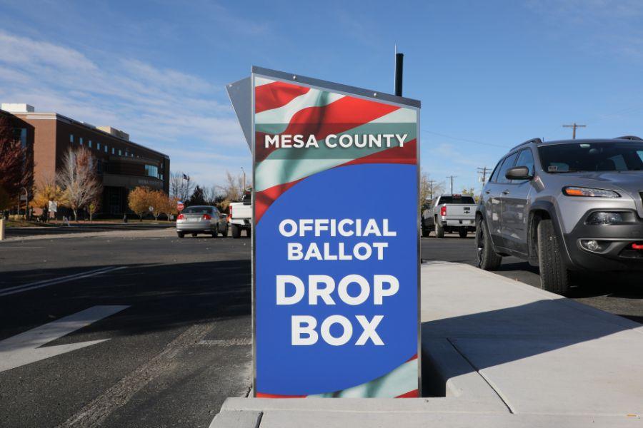 Ballot drop box with the American flag and a blue element reading, "MESA COUNTY OFFICIAL BALLOT DROP BOX." 